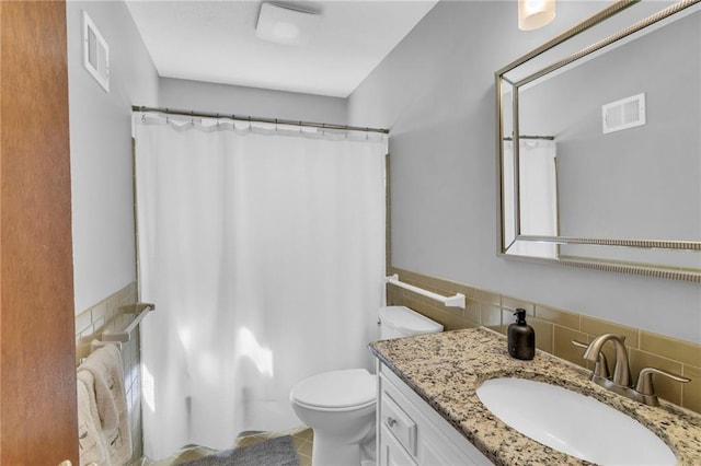 bathroom featuring visible vents, tile patterned flooring, toilet, and vanity