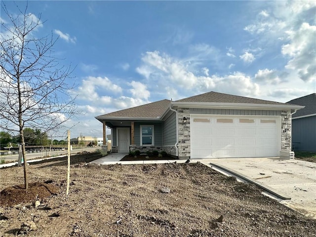 view of front of property featuring stone siding, driveway, a garage, fence, and a shingled roof