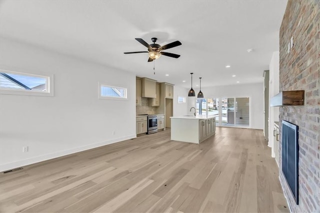 8804 NE 81st Ter, Kansas City, MO 64158 - unfurnished living room with visible vents, light wood-style flooring, ceiling fan, and a healthy amount of sunlight