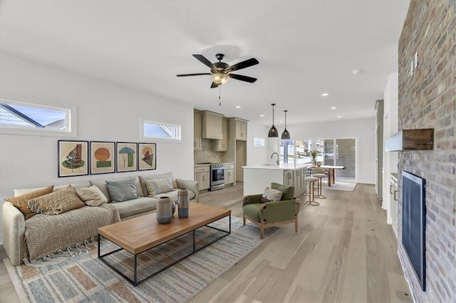 8804 NE 81st Ter, Kansas City, MO 64158 - living area featuring a ceiling fan, light wood-style flooring, a fireplace, and recessed lighting