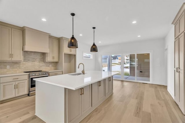8804 NE 81st Ter, Kansas City, MO 64158 - kitchen featuring decorative backsplash, stainless steel range with electric stovetop, light countertops, light wood finished floors, and a sink