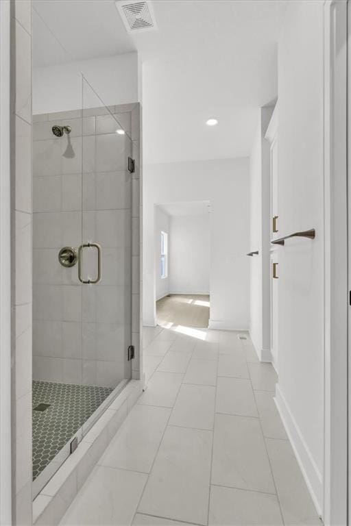 8804 NE 81st Ter, Kansas City, MO 64158 - bathroom featuring tile patterned floors, a stall shower, baseboards, and visible vents