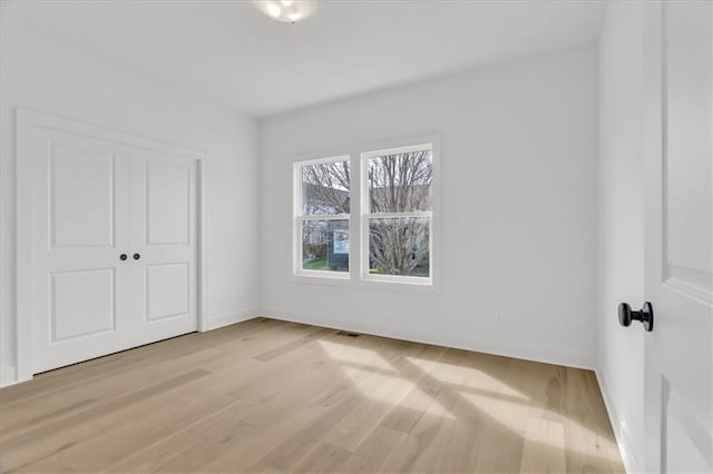 8804 NE 81st Ter, Kansas City, MO 64158 - unfurnished bedroom with baseboards, light wood-type flooring, a closet, and visible vents
