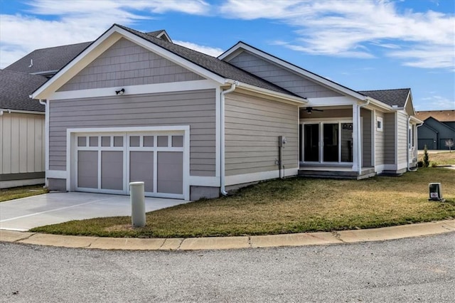 8804 NE 81st Ter, Kansas City, MO 64158 - view of front of house with a front lawn, driveway, a garage, and a ceiling fan