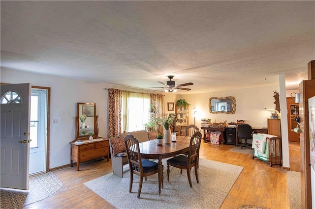 220 W John St, Milo, MO 64767 - dining area featuring light wood-type flooring, a textured ceiling, and ceiling fan