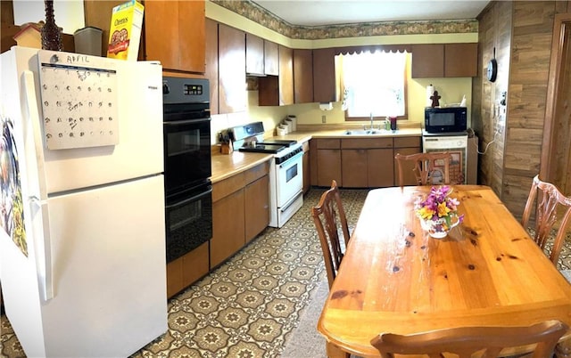 220 W John St, Milo, MO 64767 - kitchen with a sink, light countertops, black appliances, and light floors