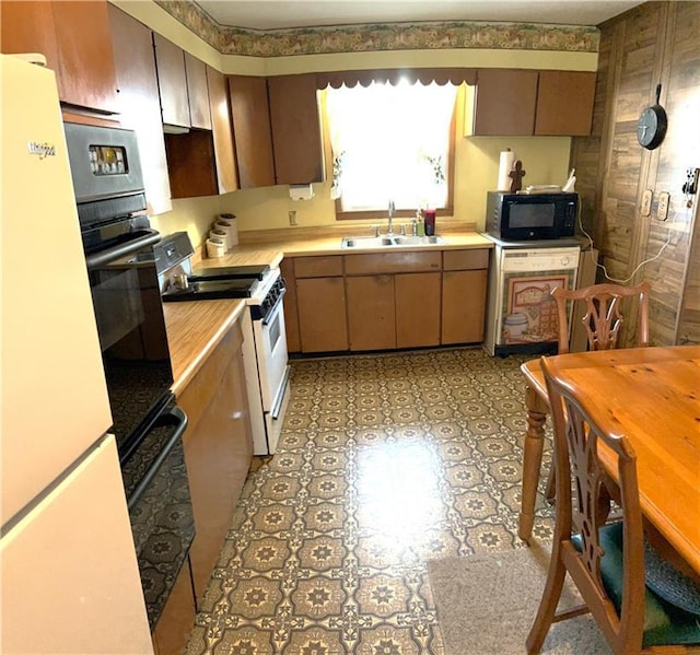 220 W John St, Milo, MO 64767 - kitchen with light countertops, a sink, white appliances, and light floors