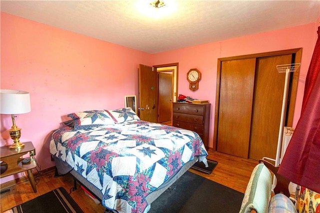 220 W John St, Milo, MO 64767 - bedroom with a closet, a textured ceiling, and wood finished floors