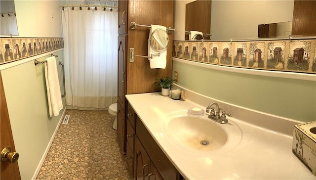 220 W John St, Milo, MO 64767 - bathroom featuring curtained shower, vanity, and toilet
