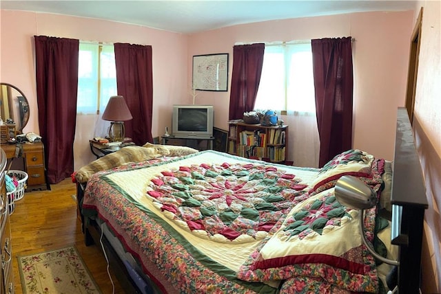 220 W John St, Milo, MO 64767 - bedroom featuring wood finished floors and multiple windows