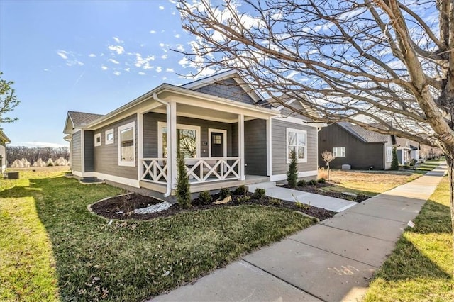 8137 N Farley Ave, Kansas City, MO 64158 - view of front of property with a front yard and covered porch