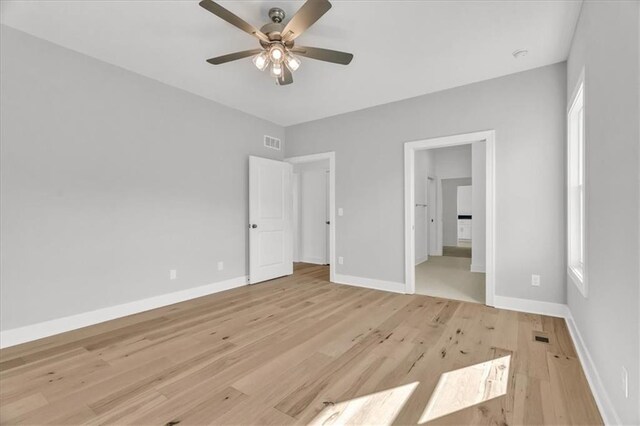 8137 N Farley Ave, Kansas City, MO 64158 - unfurnished bedroom featuring ceiling fan, baseboards, light wood finished floors, and visible vents