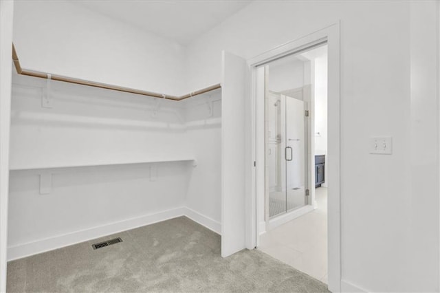 8137 N Farley Ave, Kansas City, MO 64158 - walk in closet featuring carpet floors and visible vents