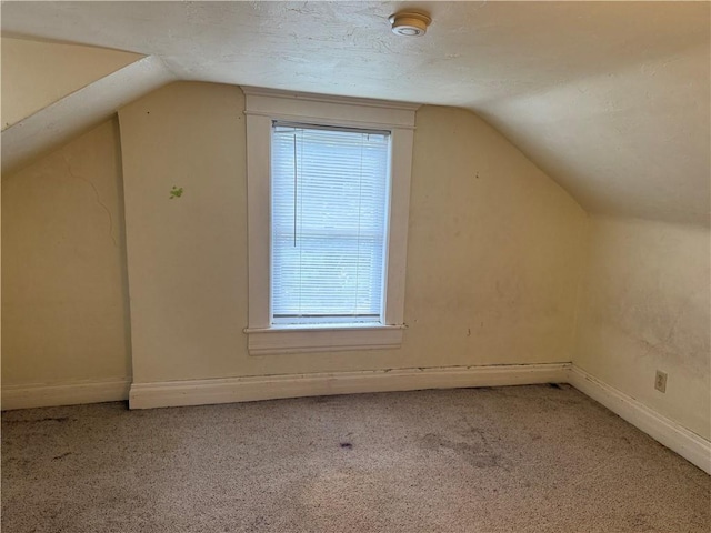 1014 S 12th St, Saint Joseph, MO 64503 - additional living space featuring vaulted ceiling, light carpet, and baseboards