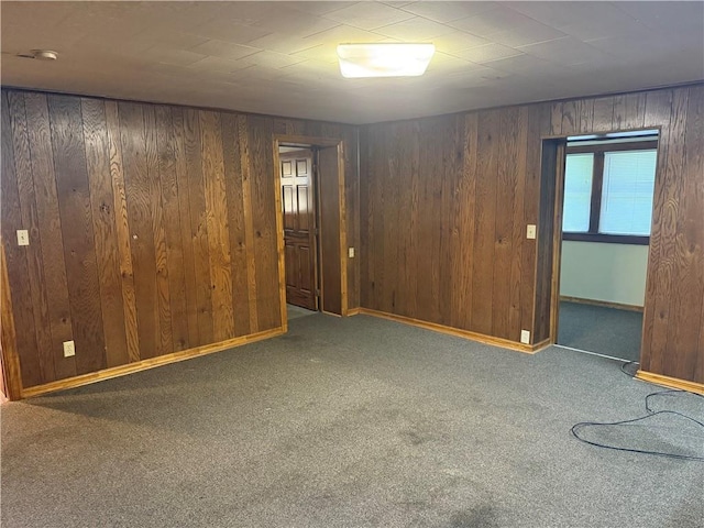 1014 S 12th St, Saint Joseph, MO 64503 - empty room featuring carpet, wood walls, and baseboards