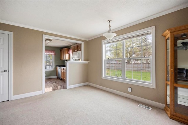508 S 7th St, Louisburg, KS 66053 - unfurnished dining area featuring light colored carpet, crown molding, and baseboards