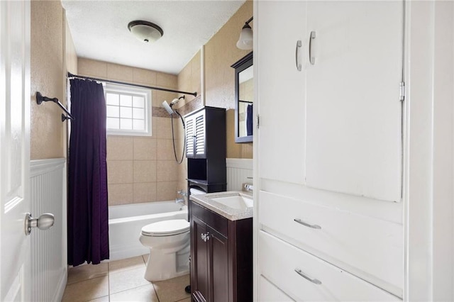508 S 7th St, Louisburg, KS 66053 - full bathroom featuring tile patterned floors, wainscoting, toilet, vanity, and shower / bath combination with curtain