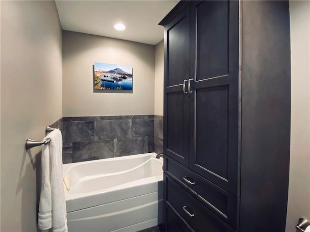 full bathroom featuring recessed lighting and a bath