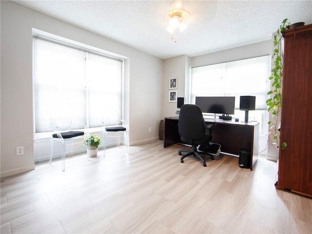 office space featuring baseboards and a textured ceiling