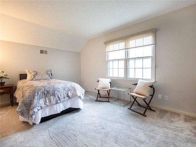 bedroom with carpet, lofted ceiling, and visible vents