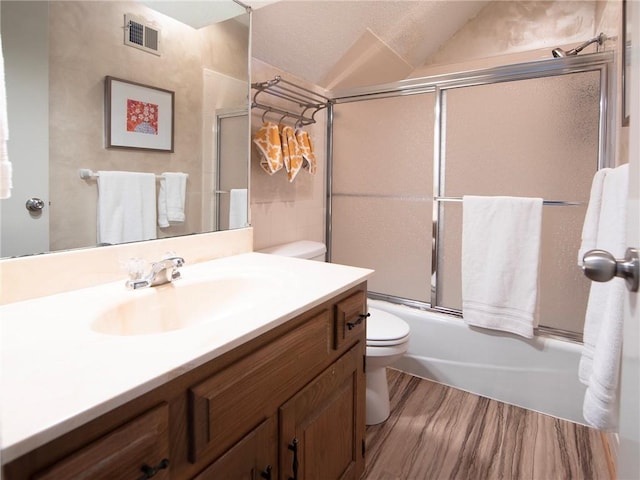 bathroom featuring visible vents, vanity, combined bath / shower with glass door, toilet, and a notable chandelier
