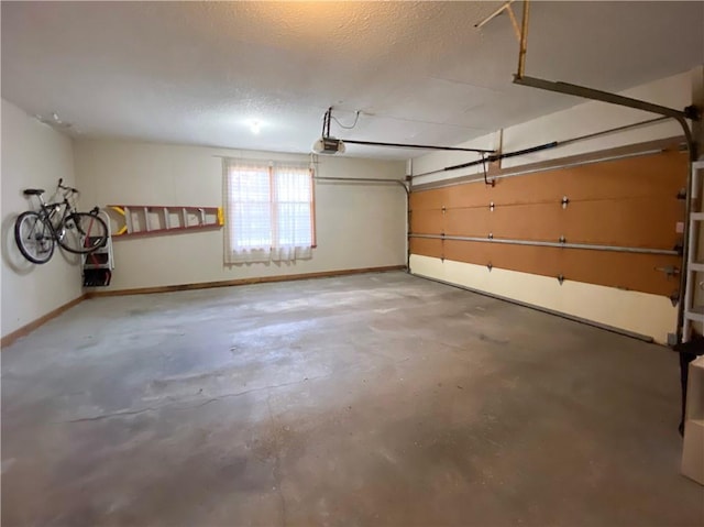 garage with baseboards and a garage door opener