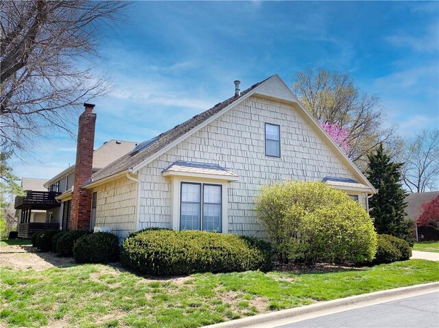 view of home's exterior with a yard and a chimney