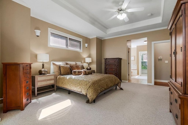 bedroom with light carpet, a raised ceiling, crown molding, connected bathroom, and ceiling fan