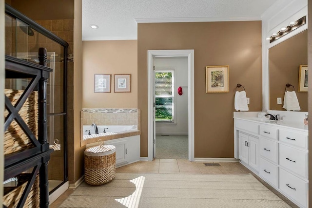 bathroom with ornamental molding, tile patterned floors, a shower stall, vanity, and a garden tub
