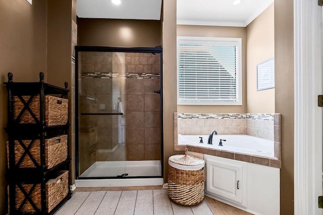 full bath with a shower stall, a bath, and crown molding