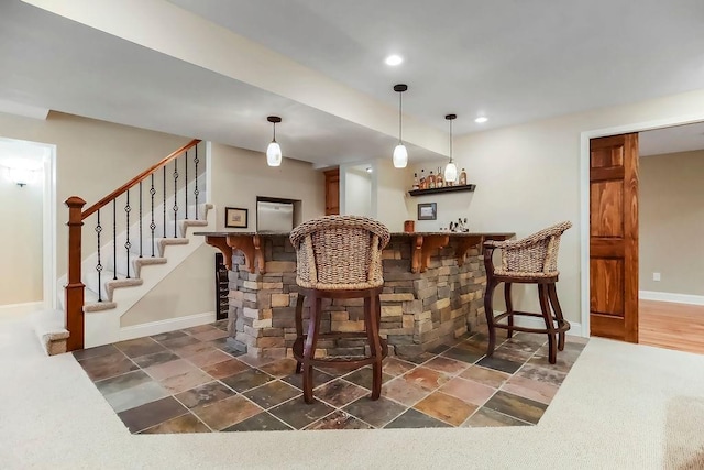 indoor bar with stairway, baseboards, recessed lighting, and pendant lighting
