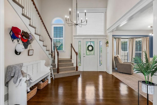 14327 King St, Overland Park, KS 66221 - foyer featuring wood finished floors, stairway, a chandelier, a high ceiling, and crown molding