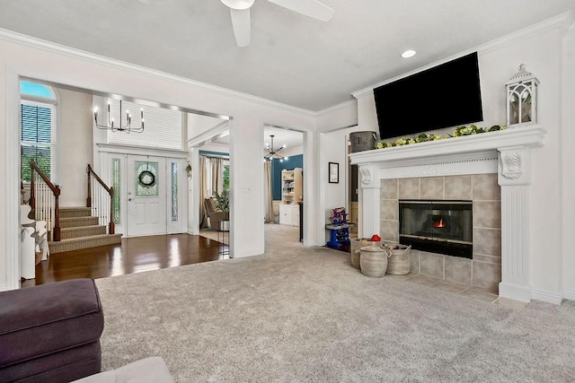 14327 King St, Overland Park, KS 66221 - living room with a chandelier, crown molding, stairway, ceiling fan, and a tile fireplace
