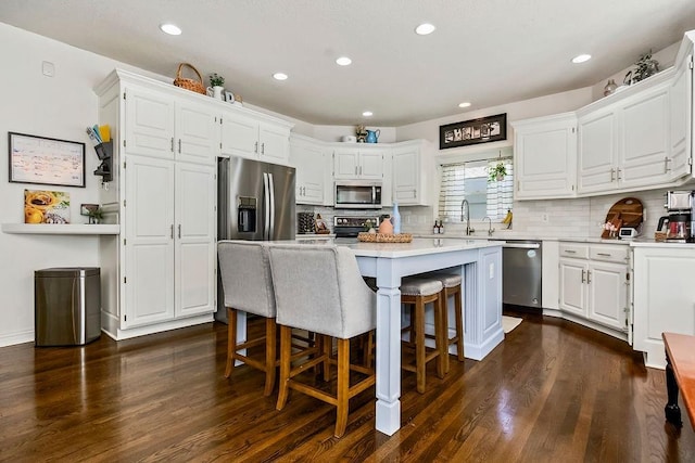 14327 King St, Overland Park, KS 66221 - kitchen featuring appliances with stainless steel finishes, dark wood-style floors, light countertops, white cabinetry, and recessed lighting