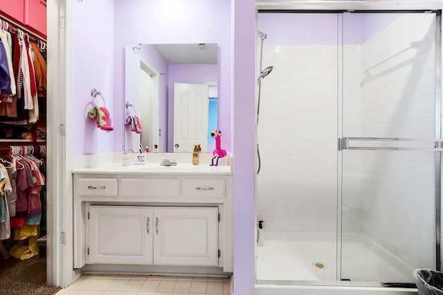 14327 King St, Overland Park, KS 66221 - bathroom with a walk in closet, vanity, and a shower stall