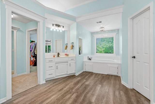 14327 King St, Overland Park, KS 66221 - full bathroom with vanity, a bath, wood finished floors, a spacious closet, and baseboards