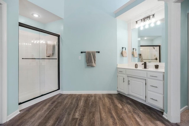 14327 King St, Overland Park, KS 66221 - bathroom featuring a tile shower, vanity, wood finished floors, and baseboards