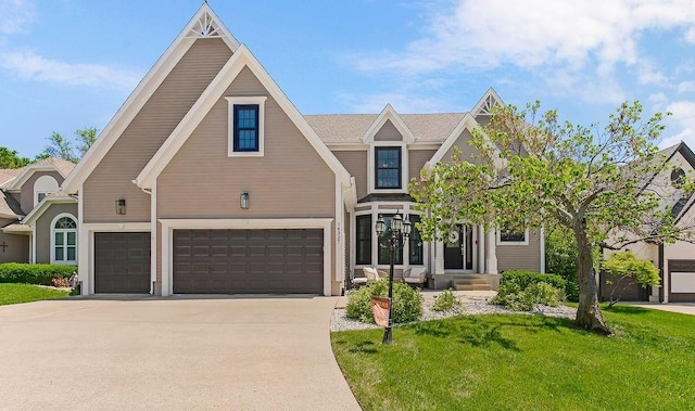 14327 King St, Overland Park, KS 66221 - view of front of home with a garage, a front yard, and driveway