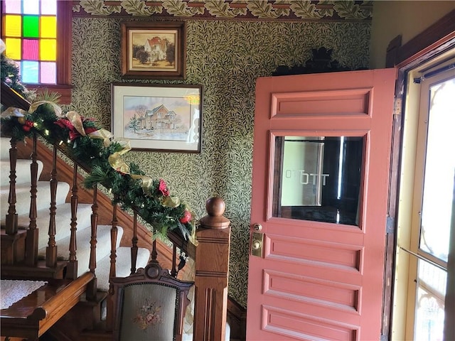 entryway featuring wallpapered walls and stairway