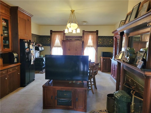 interior space featuring light colored carpet and a notable chandelier