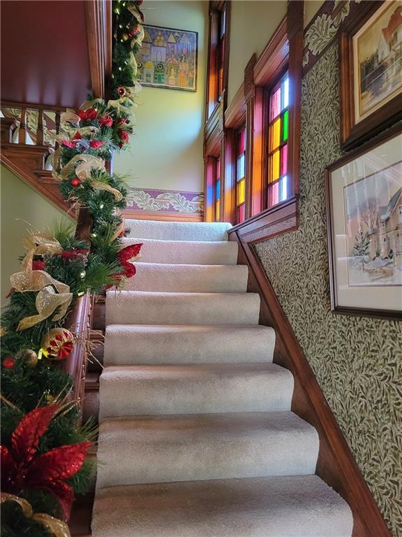 stairway with wallpapered walls