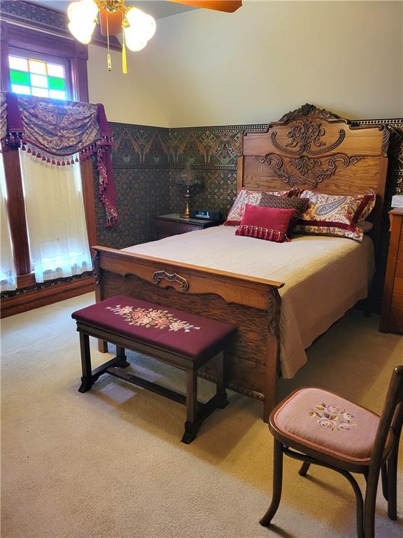 carpeted bedroom with a ceiling fan