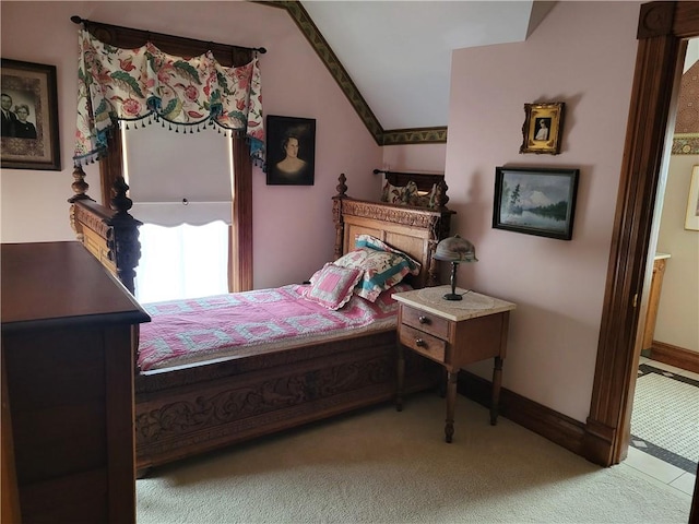 carpeted bedroom featuring vaulted ceiling and baseboards