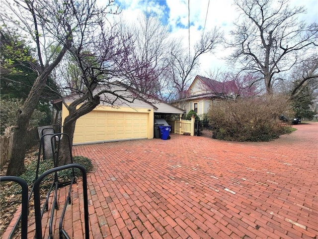 exterior space featuring fence and a garage