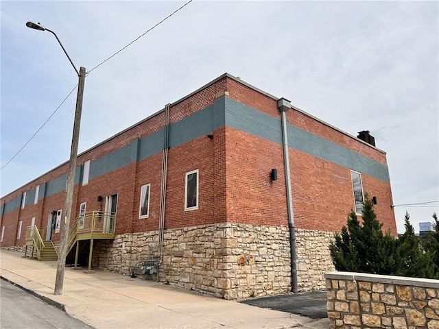 view of side of home with brick siding and stone siding