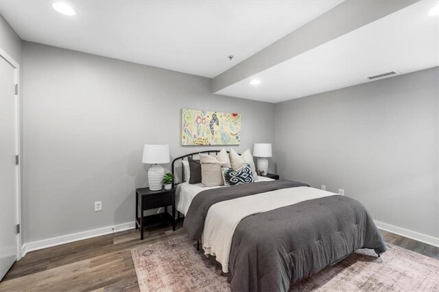 bedroom with recessed lighting, baseboards, visible vents, and wood finished floors