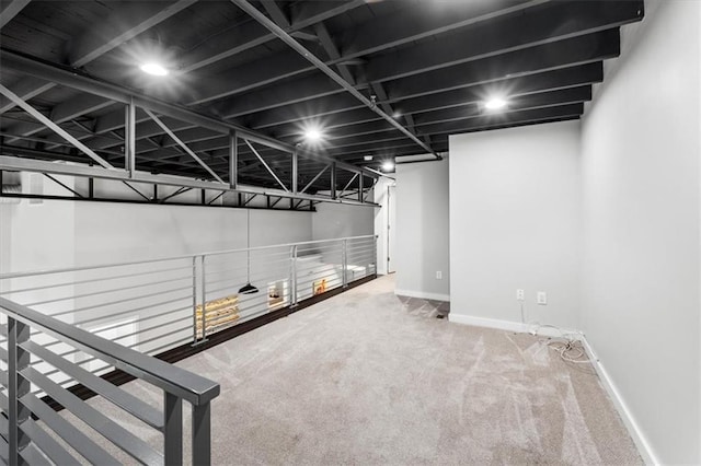 below grade area featuring carpet floors and baseboards
