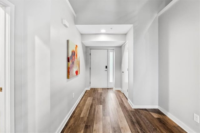 hallway featuring baseboards, recessed lighting, and dark wood-type flooring