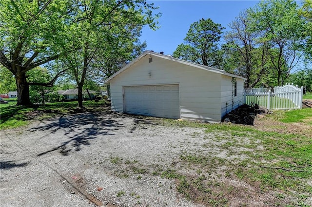 detached garage featuring fence