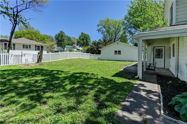view of yard featuring a fenced backyard, an outdoor structure, and a patio area